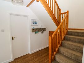 A staircase leading to an upper level in the hallway at 15 Lawnswood Saundersfoot