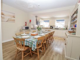 A dining area with a table set for dinner at Beach House in Winterton-On-Sea