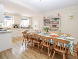 A dining room with a table set with dishes and glassware at Beach House Winterton-On-Sea