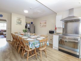 A kitchen with a dining table and chairs at Beach House in Winterton-On-Sea