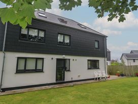 A house with a patio and chairs at Chy Holly in Carbis Bay
