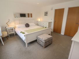 A bedroom with a bed and nightstand at Chy Holly in Carbis Bay