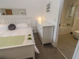 A bedroom with a bed and attached bathroom at Chy Holly in Carbis Bay