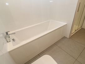 A bathroom with a bathtub and shower at Chy Holly in Carbis Bay