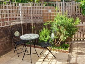 A garden with a table and two chairs at Old Ropemakers Cottage in Bridport