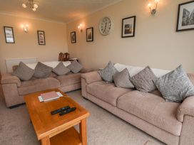 A living room with a sofa and coffee table at Sea Roke in Filey