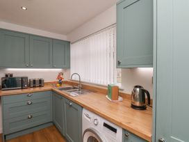 A kitchen with a sink and appliances at Sea Roke in Filey