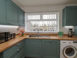 A kitchen with a sink and appliances at Sea Roke in Filey