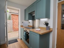 A kitchen with cabinets and cooking range at Sea Roke in Filey