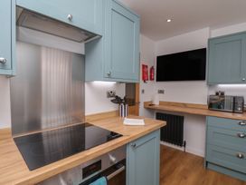 A kitchen with cabinets and appliances at Sea Roke in Filey