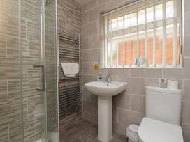 A bathroom featuring a shower, sink, toilet and towel rail at Sea Roke, Filey