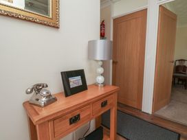 A hallway with a console table and a lamp at Sea Roke in Filey