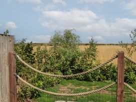 An outdoor space with a wooden fence and plants at Sea Roke in Filey