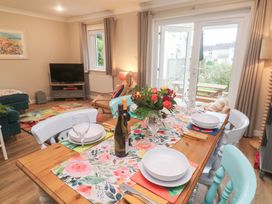 A dining room with a table set for dinner at Jaspers Retreat, formerly known as Starfish Cottage, Falmouth