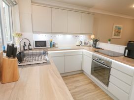 A kitchen with countertops and appliances at Jaspers Retreat, formerly known as Starfish Cottage, Falmouth