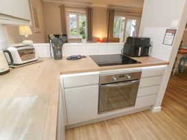 A kitchen with appliances and utensils at Jaspers Retreat, formerly known as Starfish Cottage, Falmouth