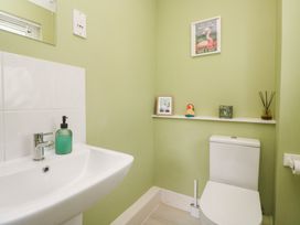 A bathroom with a toilet and sink at Jaspers Retreat, formerly known as Starfish Cottage, Falmouth