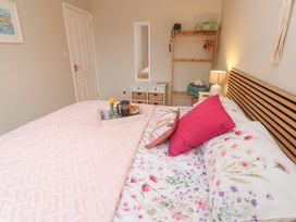 A bedroom with a bed and tray of snacks at Jaspers Retreat, formerly known as Starfish Cottage, Falmouth