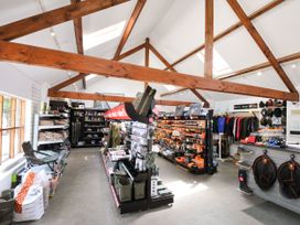 A retail space with fishing gear and clothing displays at Maple in Dolton