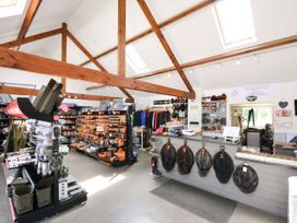 A store with fishing gear and clothing displays at Maple in Dolton