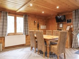 A dining room with a wooden table and chairs at Willow in Dolton