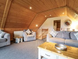 A living room with sofas and a wooden table at Willow in Dolton