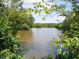 A lake surrounded by trees at Willow in Dolton