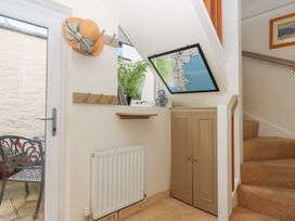 A hallway with a map and stairs at 5 Exe Street Topsham