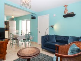 A living room featuring a sofa and dining area at 5 Exe Street Topsham