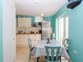 A kitchen with a table and chairs at 5 Exe Street in Topsham