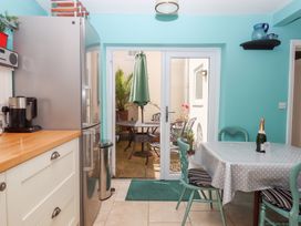 A kitchen with a table and chairs leading to a patio at 5 Exe Street Topsham