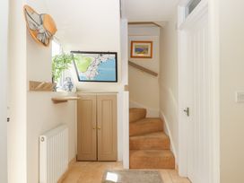 A hallway with stairs and a map at 5 Exe Street Topsham