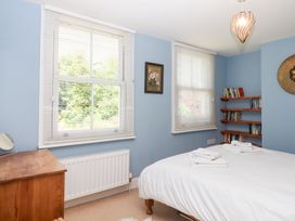 A bedroom with a bed and bookshelf at 5 Exe Street Topsham