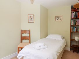 A bedroom with a single bed and a chair at 5 Exe Street Topsham
