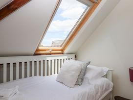 A bedroom with a bed and a sloped window at 5 Exe Street Topsham