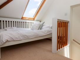 A bedroom with a bed and a window at 5 Exe Street, Topsham