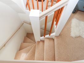 A staircase with carpet and wooden banister at 5 Exe Street Topsham