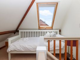 A bedroom with a bed and window at 5 Exe Street Topsham