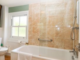 A bathroom featuring a bathtub and toilet at 5 Exe Street Topsham