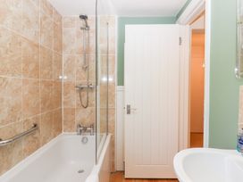 A bathroom with a bathtub and shower at 5 Exe Street Topsham