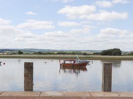 A boat on water with poles in the foreground at 5 Exe Street Topsham