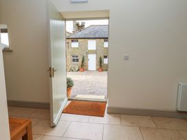 An entrance hall with a door leading to a courtyard at Cragg Lodge in West Woodburn