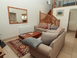 A living room with a sofa and coffee table at Cragg Lodge in West Woodburn