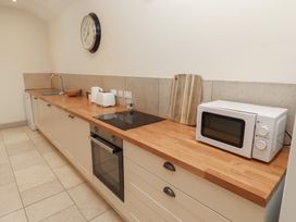 A kitchen with appliances and a countertop at Cragg Lodge West Woodburn
