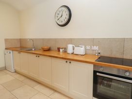 A kitchen with a sink, kettle, toaster, and oven at Cragg Lodge in West Woodburn