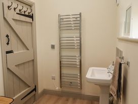A bathroom with a sink and towel rail at Cragg Lodge in West Woodburn