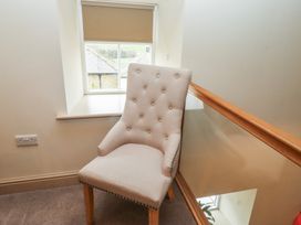 A chair next to a window on the landing at Cragg Lodge in West Woodburn