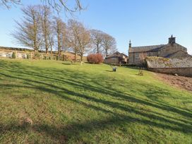 An outdoor scene with grass and trees at Cragg Lodge West Woodburn