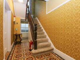 A staircase and hallway table in a hallway at Southbourne Manor Llandudno