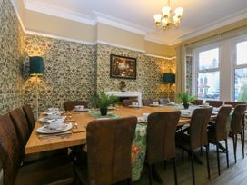 A dining room with a large table and chairs at Southbourne Manor in Llandudno